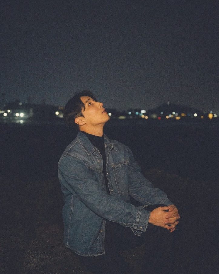 Sitting by the sea at night, looking up
