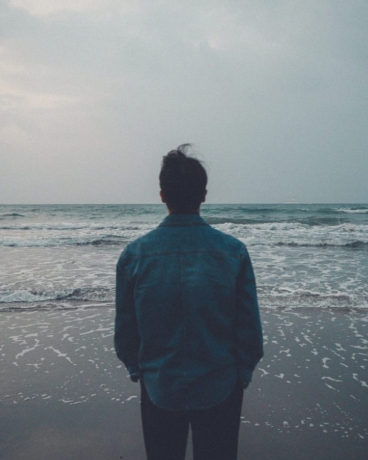 Standing alone facing the waves